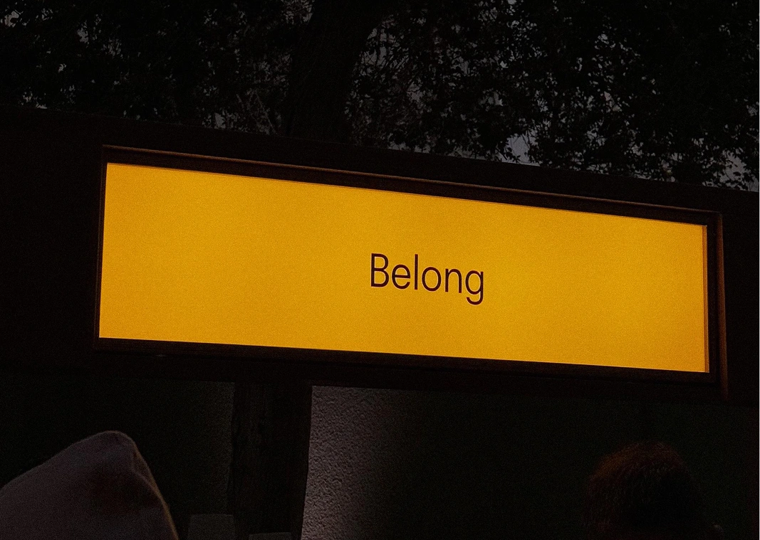 Illuminated Belong sign at night