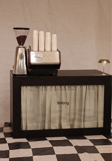 Belong coffee cart with espresso machine on a checkered floor